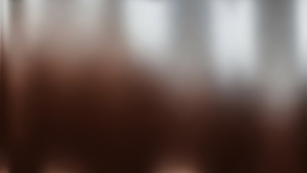 A blurry image of a white and brown background photo