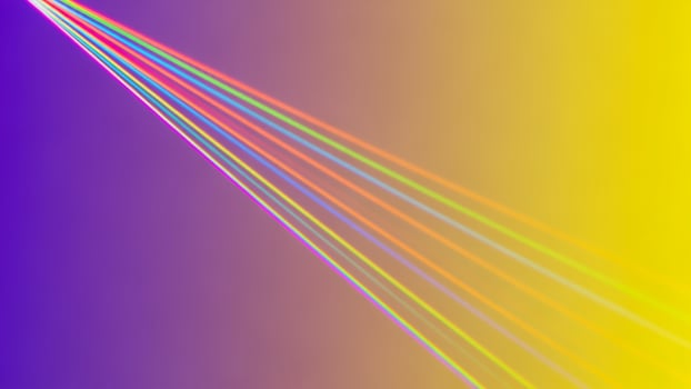 A rainbow colored background with a bright light photo