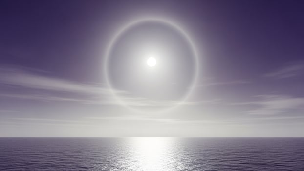 A large circle of light over the ocean photo