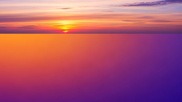 A sunset over the ocean with a purple and orange sky photo
