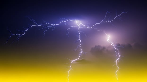 Lightning bolt over the yellow and blue sky photo