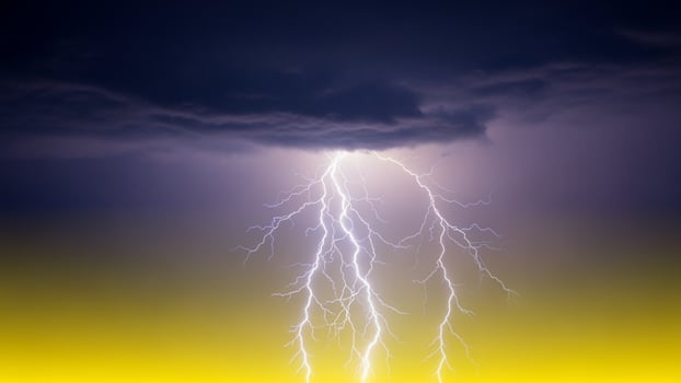 Lightning strike over the yellow and black sky photo