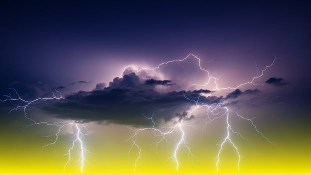 Lightning storm over the clouds with yellow and purple background photo