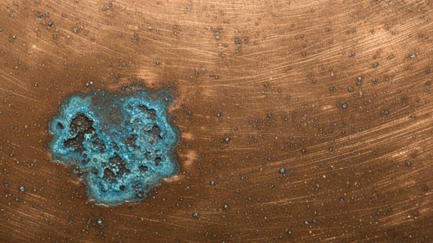 A blue and green object on a metal surface photo