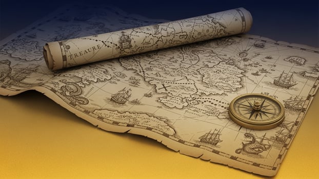 An old map with a compass and a roll of paper photo