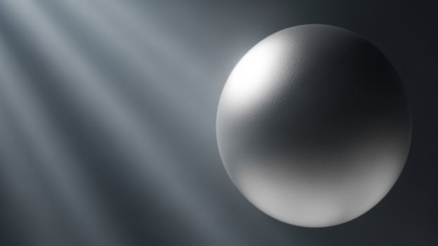 A silver egg is shown in the light photo