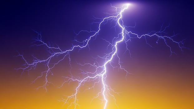 Lightning bolt on the sky with a yellow and orange background photo