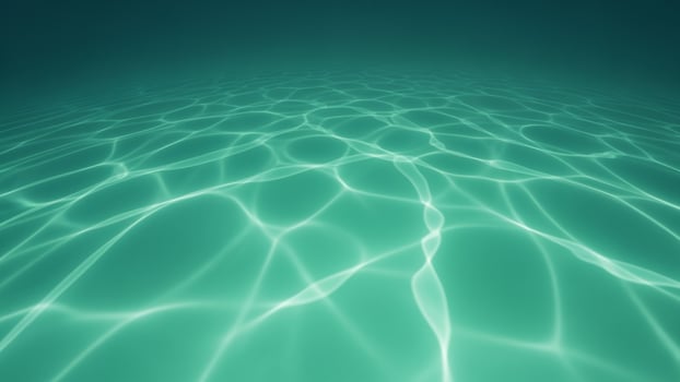 A green surface with water ripples photo