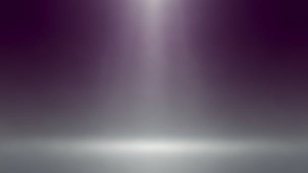 A purple light is shining in the middle of a dark room photo
