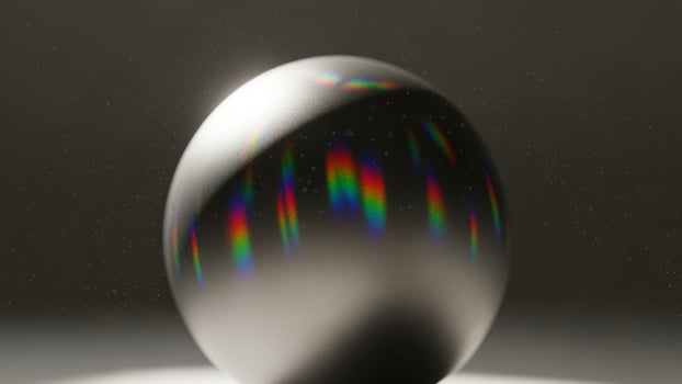 A shiny ball with rainbow light reflected on it photo