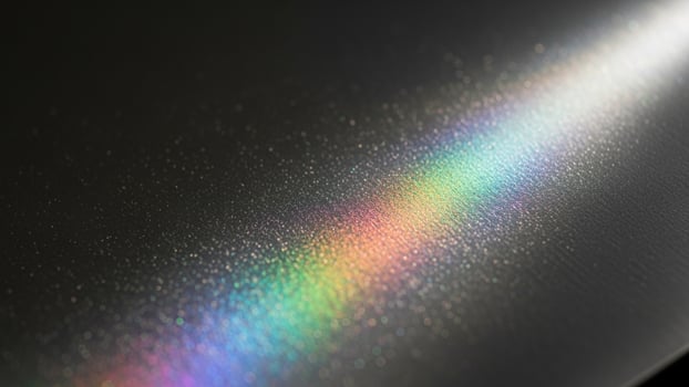 A rainbow is seen on a black surface photo