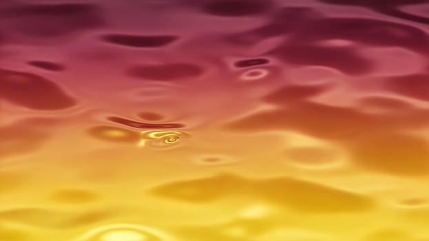 Water drops on a surface with a yellow and red background photo