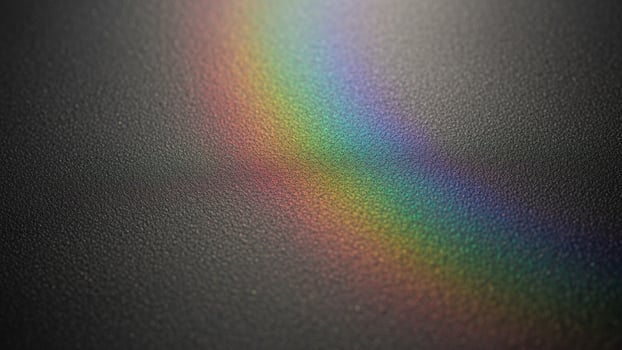 Rainbow light on black surface photo
