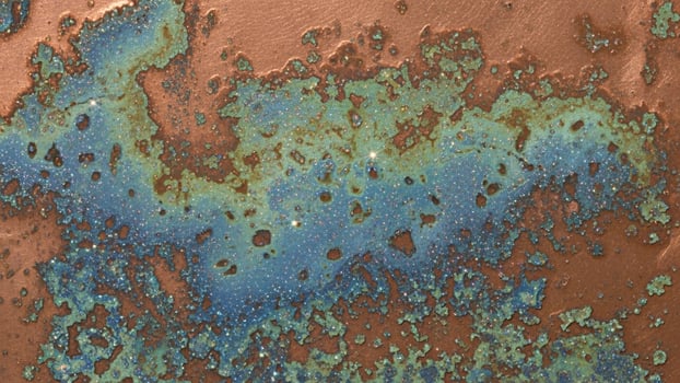 A rusty metal surface with blue and green paint photo