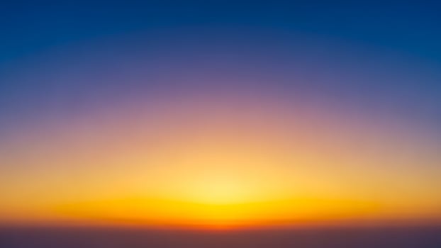 A blurry image of the sun setting over the horizon photo