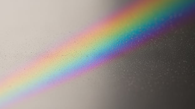 A rainbow is seen in the middle of a glass surface photo