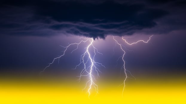Lightning strike over a yellow and black background photo