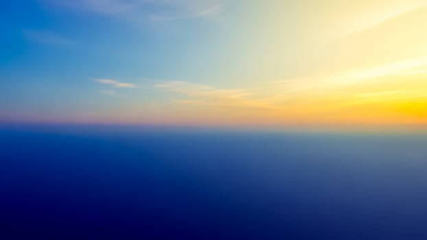 A blue sky with a yellow sun in the background photo