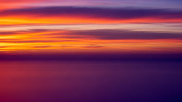 A long exposure photograph of a colorful sunset photo
