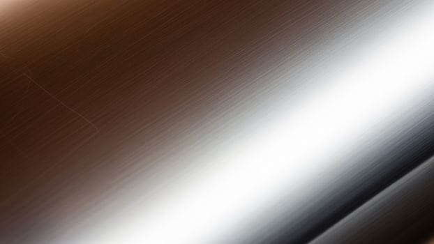 A shiny metal surface with a white and black background photo