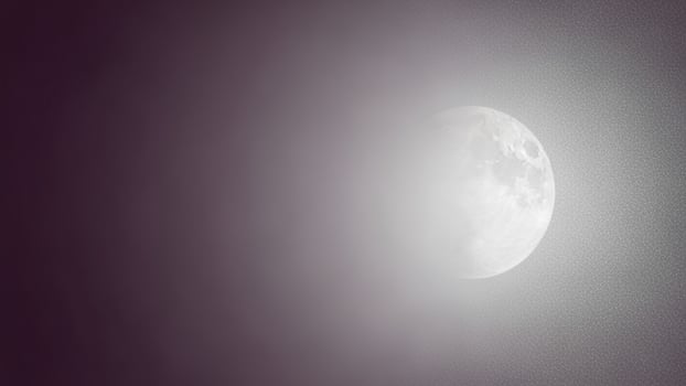 A full moon is seen in the dark sky photo