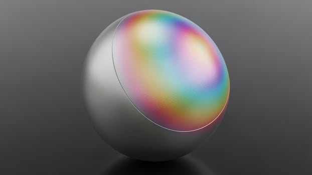 A shiny ball with a rainbow colored light on it photo