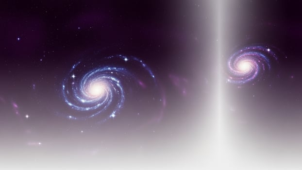 Two spiral galaxies are shown in the sky photo