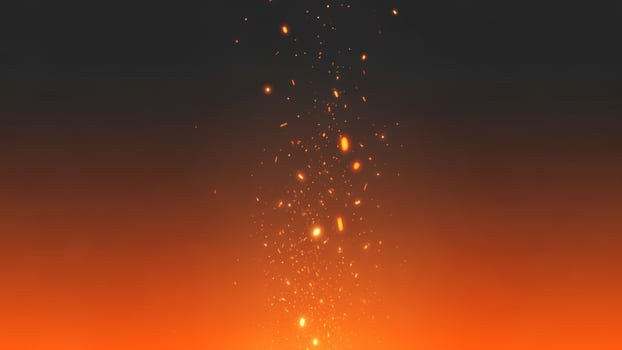 An orange fire with sparks flying out of it photo