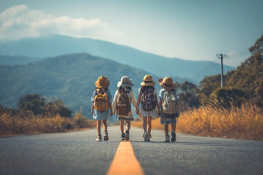 Four Young Friends Journey Down a Mountain Road Together. photo