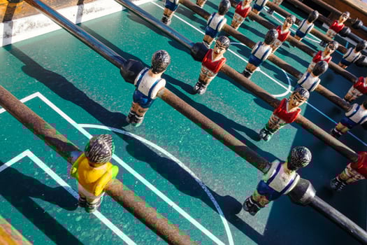 Close view of the green field of a foosball table sports game concept photo