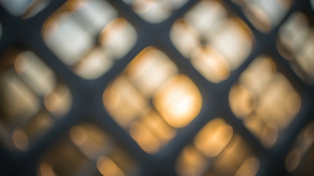 Abstract background of a lattice fence with the sun shining through photo