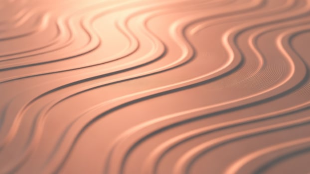 A close up of a wavy surface with a metallic finish photo