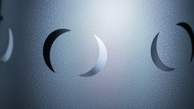A close up of a metal object with three circles photo