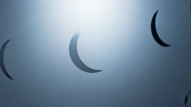 A close up of a metal wall with a crescent moon photo