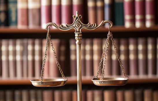 Scales of justice with antique book collection symbolizing legal system and balance photo