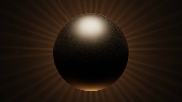 A black egg with a white center on a dark background photo