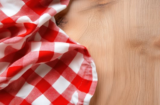 Red and white checkered tablecloth on wood background texture photo