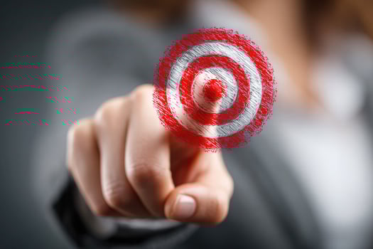 Businesswoman pointing at red target symbol. Focus on hand and bullseye, symbolizing goals, strategy, precision, and success in business or personal development photo