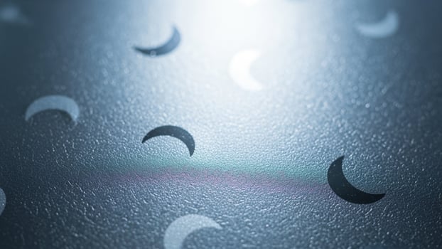 A close up of a metal surface with a few moon shapes photo