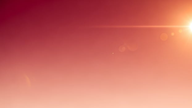 A man is standing on a hill with a red sky photo