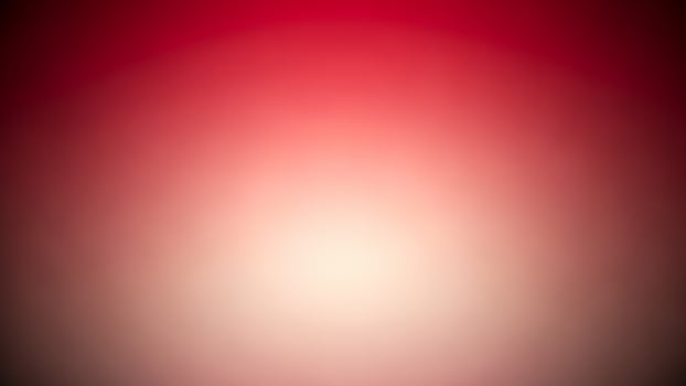 A red and white blurred background with a bright light photo
