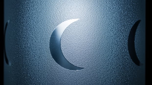 A metal cylinder with a crescent moon on it photo