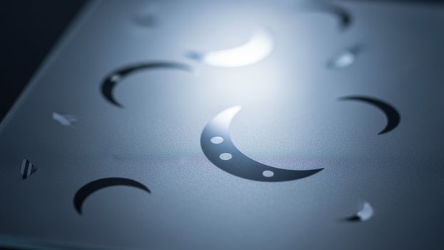 A close up of a metal plate with crescent shapes photo