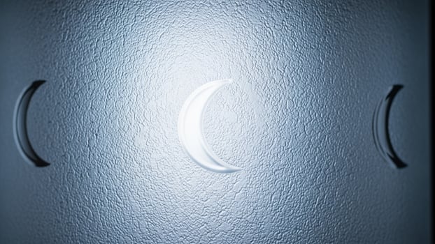 A close up of a crescent moon on a wall photo