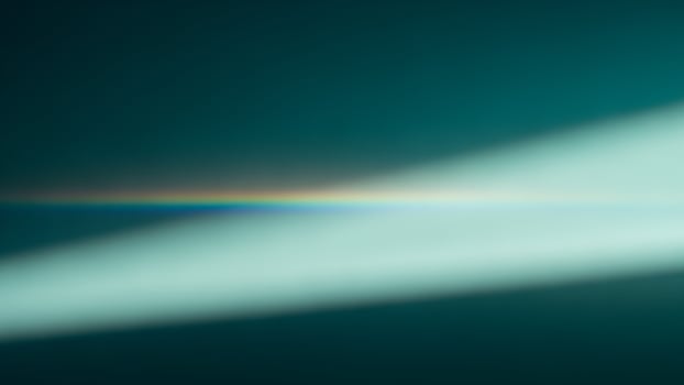 A rainbow light shining on a dark background photo