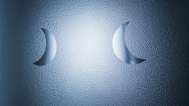 A close up of two crescent shaped holes on a wall photo