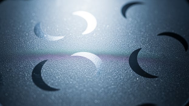 A close up of a metal surface with a circle of moon phases photo