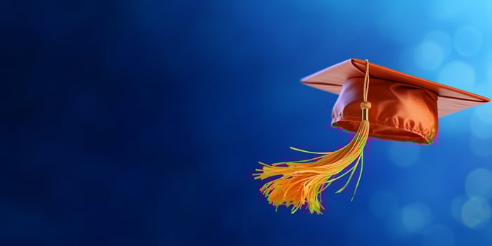 Graduation cap on blurred blue background education achievement photo