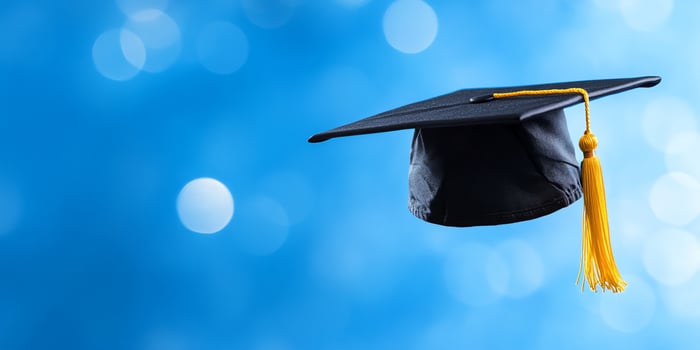 Graduation cap academic achievement symbol against blue bokeh background photo