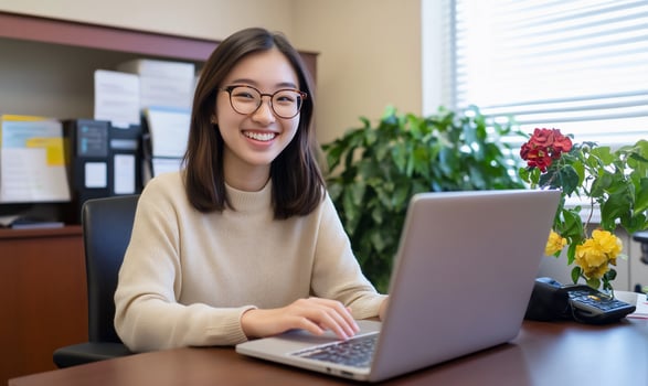 Smiling young woman typing at laptop in bright office environment remote work and online education photo